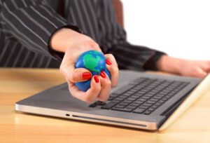 Close up of a woman at a laptop squeezing a stress ball